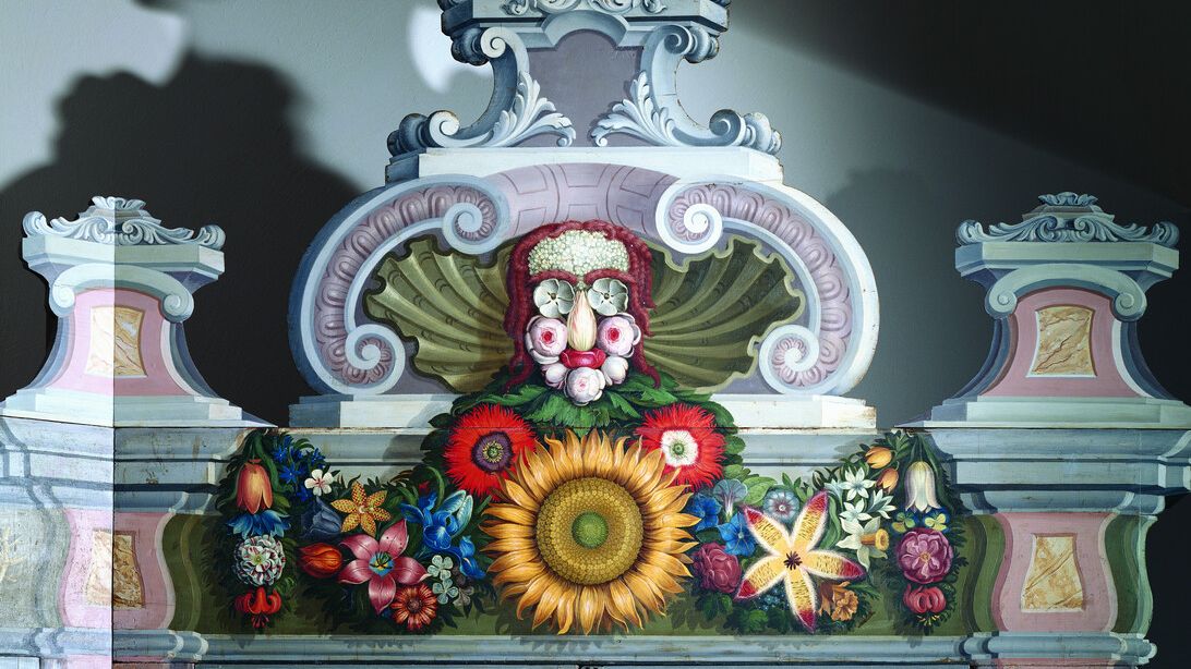 Close-up of a floral face motif adorning the top of a historical plant cabinet from the Cabinet of Curiosities, inspired by the style of Giuseppe Arcimboldo. (Poster)